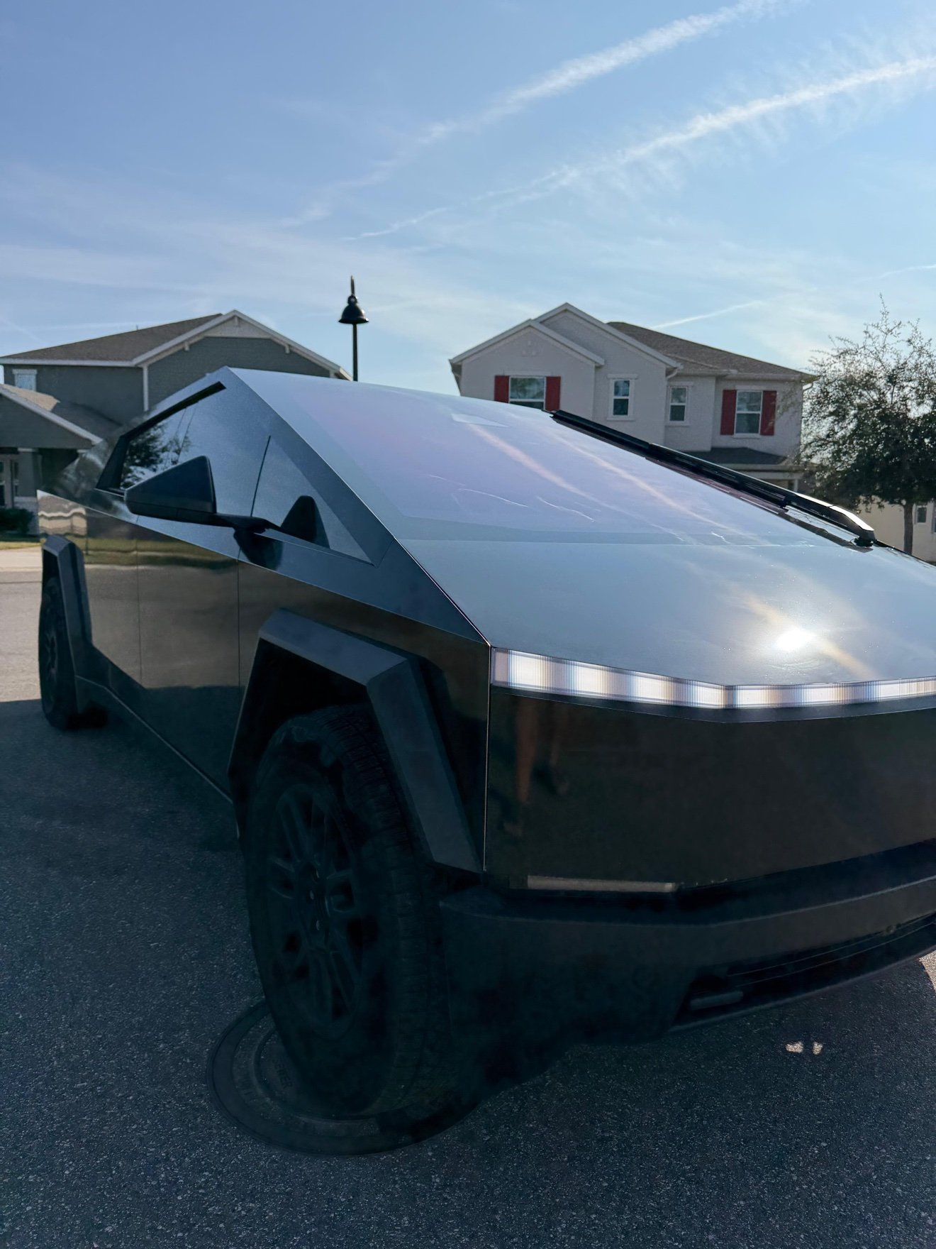 Tesla Cybertruck wrapped in satin black, front three-quarter view