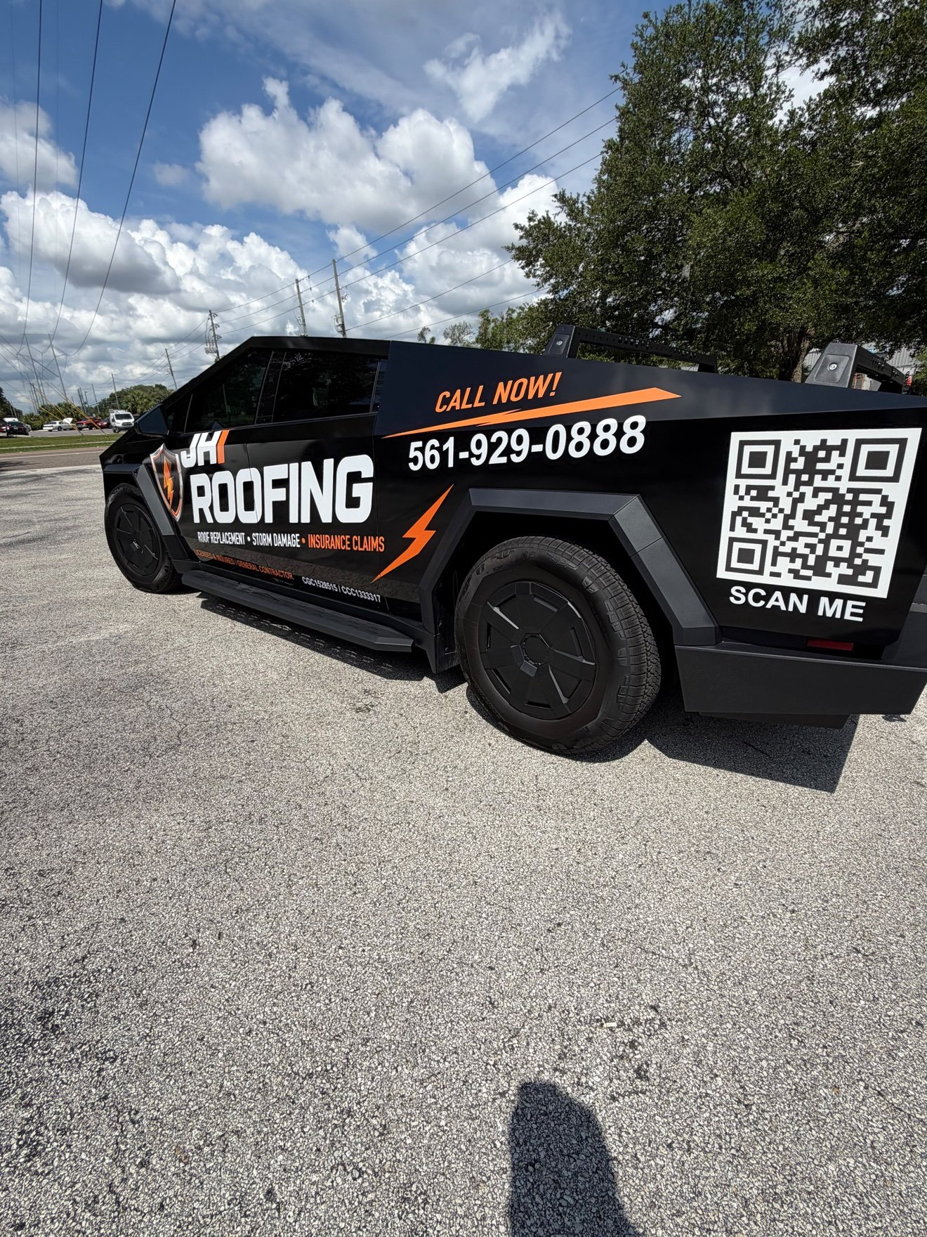 Tesla Cybertruck wrapped for JH Roofing, rear view with a large QR code and phone number