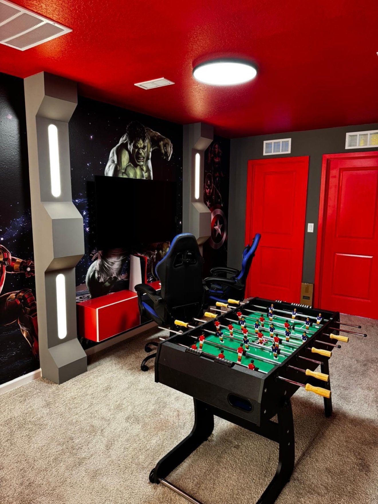 Avengers themed game room with a foosball table and superhero graphics