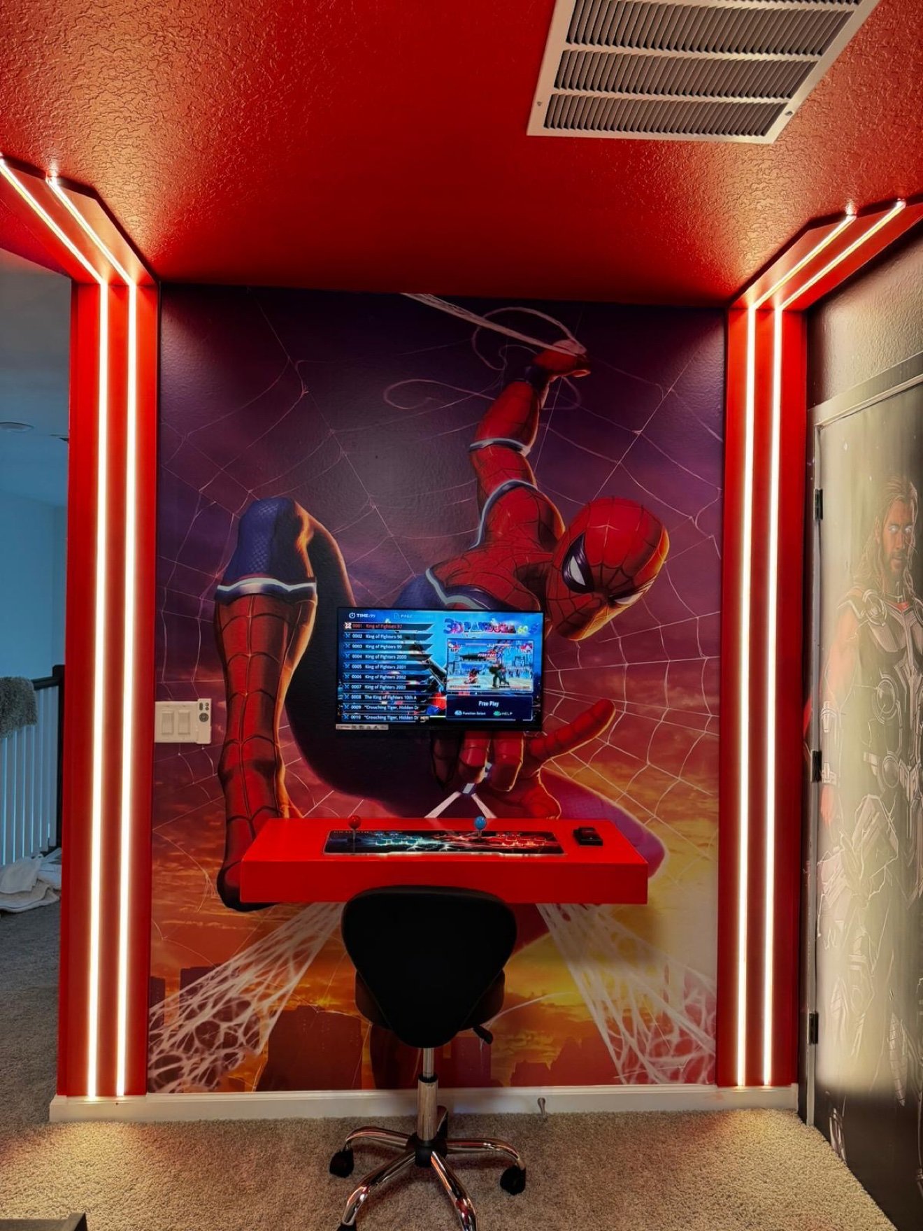 Spider-Man themed game room with an arcade machine and wall graphics